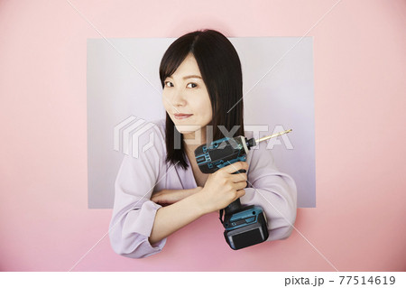 DIY woman stock image. Electric screwdriver 77514619