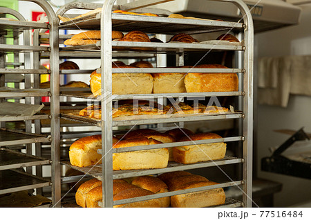 Trolley with baked bread in bakery Trolley with baked bread in bakery 77516484