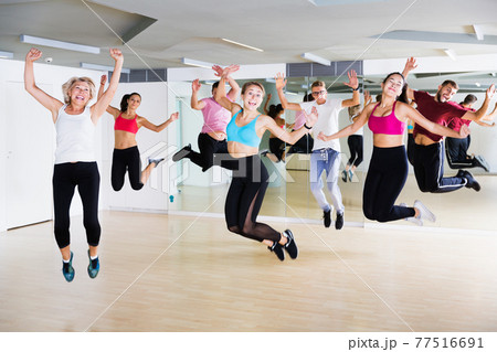 Adults jumping at dance class Adults jumping at dance class 77516691