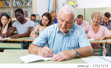 Mature man take a written exam Mature man take a written exam 77517174