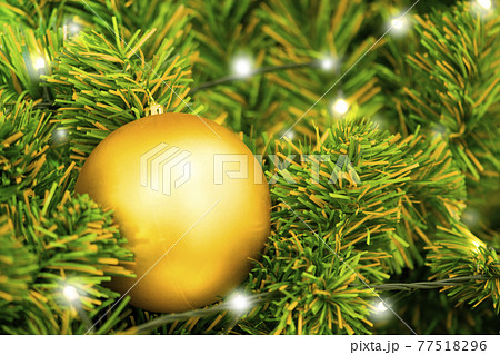Christmas ball on tree. Closeup on Christmas tree decoration over festive background Christmas ball on tree. Closeup on Christmas tree decoration over festive background 77518296