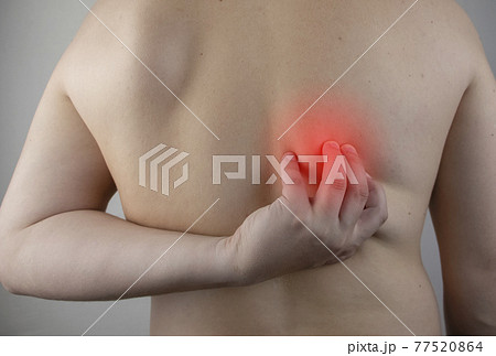 Shoulder pain. A man at a doctor appointment with a vertebrologist complaining of pain in the interscapular region and back. Shoulder pain. A man at a doctor appointment with a vertebrologist complaining of pain in the interscapular region and back. 77520864