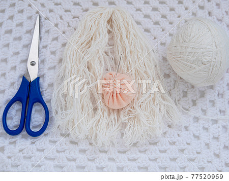 Scandinavian gnome with long beard red hat white knit background step by step handmade tutorial. Homemade DIY 77520969
