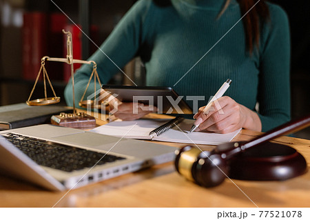 Justice and law concept.Male judge in a courtroom with the gavel, working Justice and law concept.Male judge in a courtroom with the gavel, working 77521078