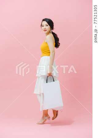 Shopping Smiling fashion woman holding white packets. 77521305