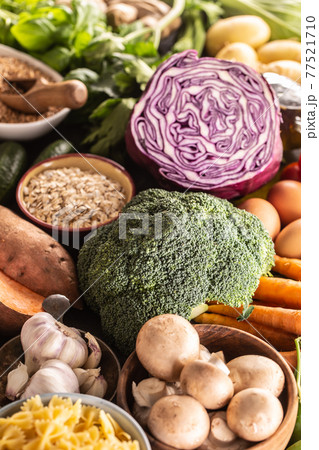 Choice of fresh food and healthy eating focused on broccoli. Vegetables, fruits, legumes and cereals on a concrete table Choice of fresh food and healthy eating focused on broccoli. Vegetables, fruits, legumes and cereals on a concrete table 77521710