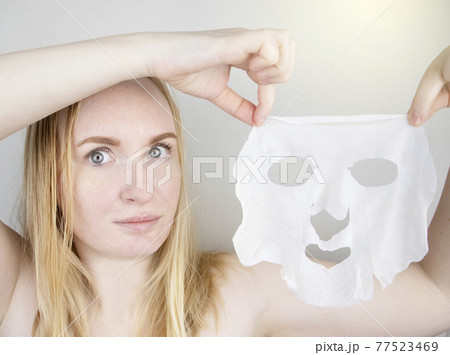 A cheerful and funny girl fooling around and grimacing in a moisturizing face mask. Morning beauty treatments, oily and combination skin care concept. A cheerful and funny girl fooling around and grimacing in a moisturizing face mask. Morning beauty treatments, oily and combination skin care concept. 77523469