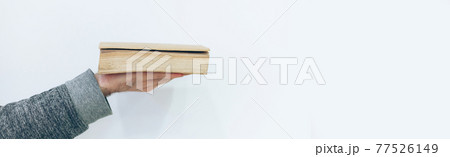 Man holding close old paper book Man holding close old paper book 77526149