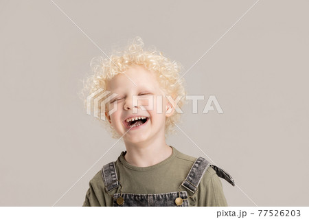 Portrait of little preschool boy posing isolated over gray studio background. Portrait of little preschool boy posing isolated over gray studio background. 77526203