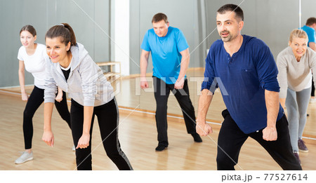 Woman training at group dance class 77527614