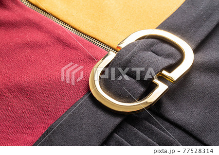 Beautiful belt with a golden buckle on an elegant dress, macro. Stylish Beautiful belt with a golden buckle on an elegant dress, macro. Stylish 77528314