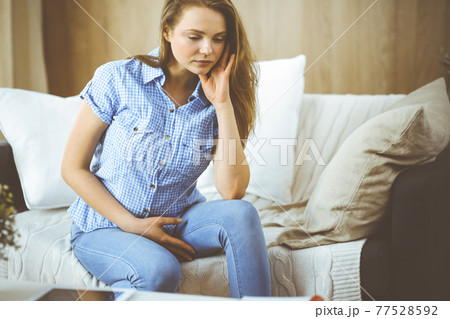 Tired upset woman worried about tiredness from domestic work and self isolation quarantine for COVID-19 Coronavirus. Mental health, anxiety depressed thinking young lady Tired upset woman worried about tiredness from domestic work and self isolation quarantine for COVID-19 Coronavirus. Mental health, anxiety depressed thinking young lady 77528592