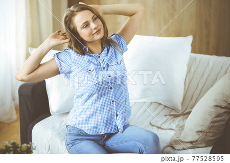 Happy blond woman put hands behind head sitting leaned on couch caucasian female enjoy lazy weekend or vacation in cozy living room, housewife relaxing feels satisfied accomplish chores housework Happy blond woman put hands behind head sitting leaned on couch caucasian female enjoy lazy weekend or vacation in cozy living room, housewife relaxing feels satisfied accomplish chores housework 77528595