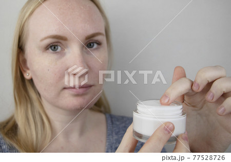 A woman examines dry skin on her face. Peeling, coarsening, discomfort, skin sensitivity. Patient at the appointment of a dermatologist or cosmetologist, selection of cream for dryness A woman examines dry skin on her face. Peeling, coarsening, discomfort, skin sensitivity. Patient at the appointment of a dermatologist or cosmetologist, selection of cream for dryness 77528726