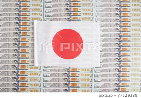 Japan flag on a background from dollar banknotes. Concept of the relationship of the Japanese money in relation to the dollar, the country's economy, financial 77529339