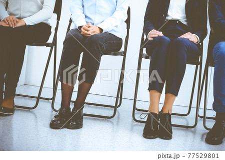 Group of business people sitting in office and waiting for job interview while using gadgets. Conference or training concepts 77529801