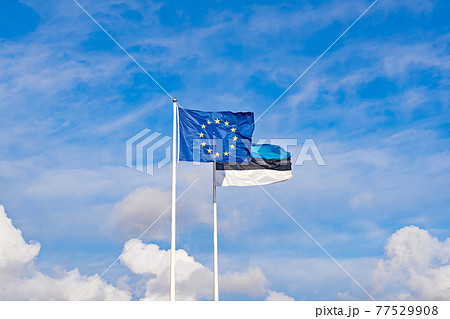 Two waving flags of European Union and Estonia against blue sky, copy space Two waving flags of European Union and Estonia against blue sky, copy space 77529908