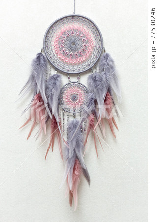 Handmade dream catcher with feathers threads and beads rope hanging on white background Handmade dream catcher with feathers threads and beads rope hanging on white background 77530246