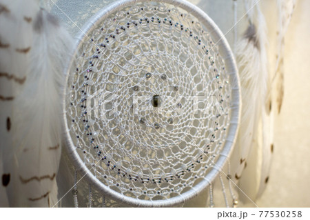 Handmade dream catcher with feathers threads and beads rope hanging on white background 77530258