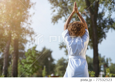 Afro American female child doing meditation exercise outdoors 77532523