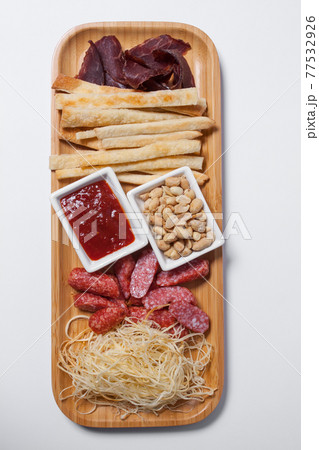 set of beer snacks with salami, peanuts, cheddar cheese and ketchup 77532926