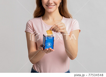 Lady Putting Card With Paper Bag Icon Into Blue Toy Garbage Container 77534548