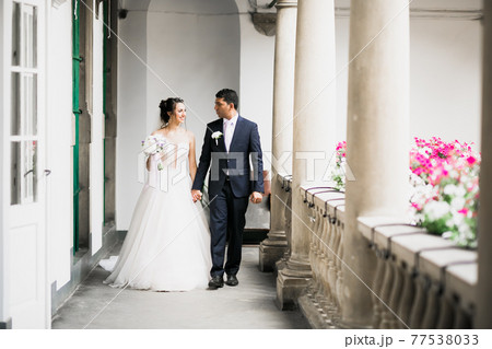 Wedding couple holding hands, groom and bride together on wedding day Wedding couple holding hands, groom and bride together on wedding day 77538033