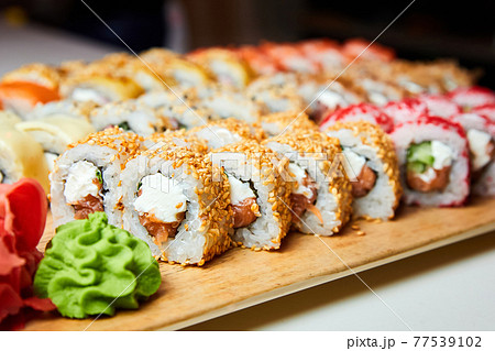 Set of various sushi rolls on a board. Close-up, selective focus 77539102