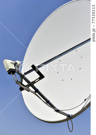 White satellite dish on blue sky background White satellite dish on blue sky background 77539213