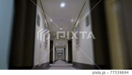 Timelapse of moving forward in empty light hotel corridor 77539694
