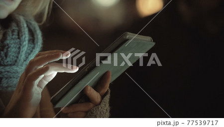 Female Typing on Tablet PC Outdoor 77539717