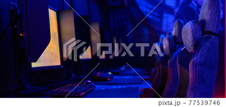 Cybercafe tables with computers in row 77539746