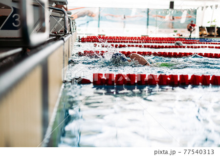 Swimming to the target during the race at the pool 77540313