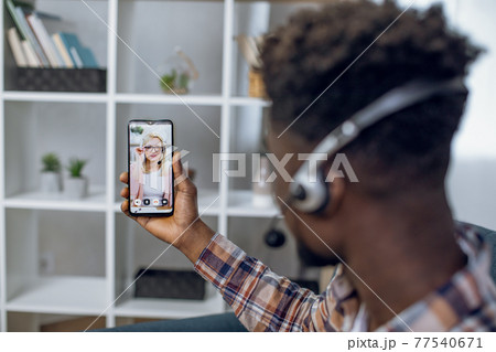 African man having online lesson on smartphone African man having online lesson on smartphone 77540671