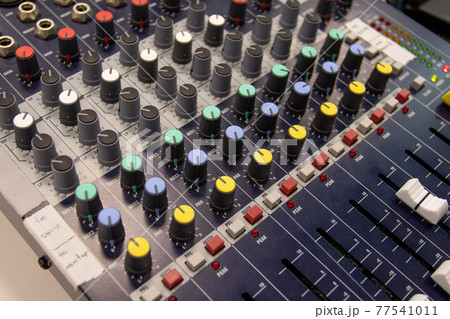 Close up of a music sound mixer at an outdoor, indoor event Close up of a music sound mixer at an outdoor, indoor event 77541011