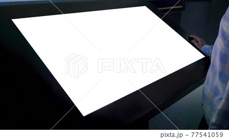 Woman looking at blank white display kiosk at exhibition - white screen concept Woman looking at blank white display kiosk at exhibition - white screen concept 77541059