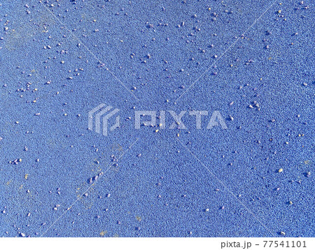 The blue texture of the soft rubber surface of the safe cover of the sports playground for workout made of pressed fine rubber. The background. Texture The blue texture of the soft rubber surface of the safe cover of the sports playground for workout made of pressed fine rubber. The background. Texture 77541101