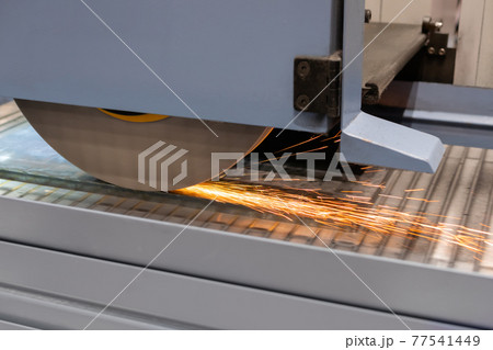 Surface grinding wheel machine working with sheet metal with sparks at factory 77541449