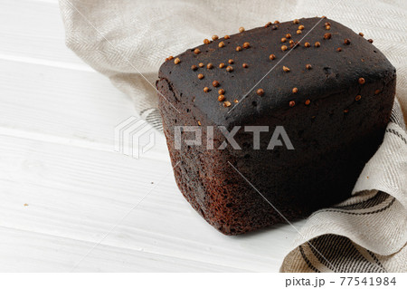 Loaf of rye bread on white wooden table Loaf of rye bread on white wooden table 77541984