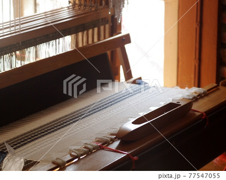 close-up parts of a manual small weaving machine for making education arts and crafts textiles with local traditional materials and yarns in a university's fashion and textiles workshop 77547055