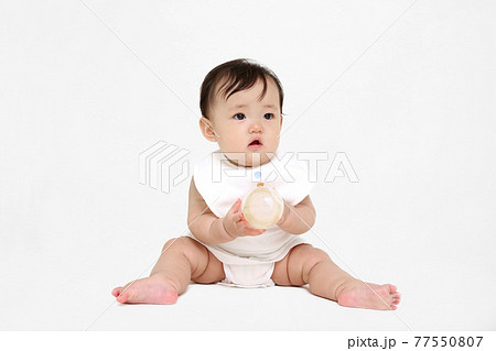 白背景でお座りする女の子の赤ちゃん。成長,健康,元気,育児イメージ 白背景でお座りする女の子の赤ちゃん。成長,健康,元気,育児イメージ 77550807