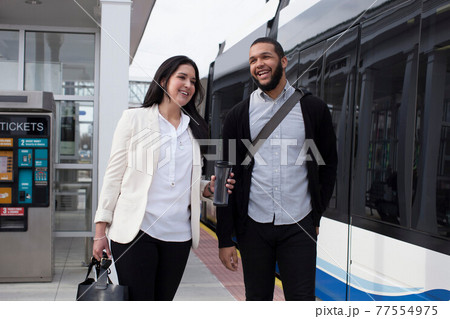 Young couple on platform with light train Young couple on platform with light train 77554975