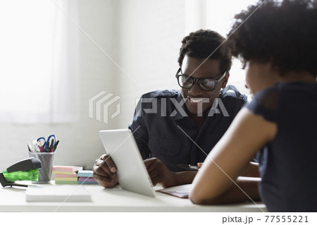 Two colleagues working with digital tablet 77555221