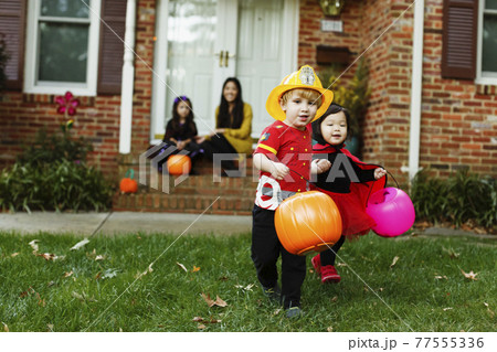 Boy dressed as fireman with trick or treat bucket Boy dressed as fireman with trick or treat bucket 77555336