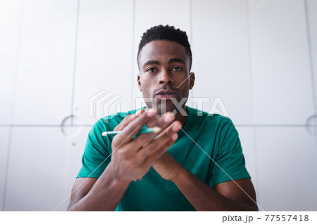 African american businessman sitting in office having video call and making notes 77557418