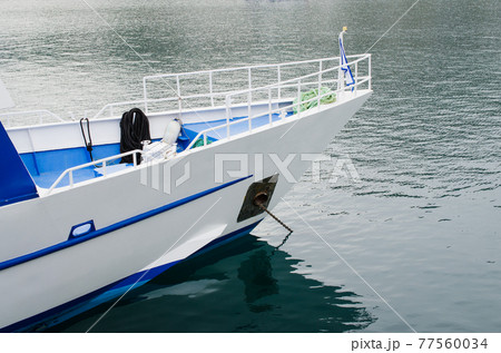 Bow of a pleasure yacht anchored. Empty tourist boat. 77560034