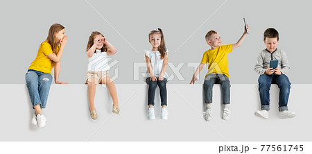 Art collage made of portraits of little and happy kids isolated on white studio background. Human emotions, facial expression concept 77561745