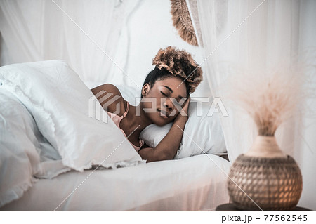 Dark skinned woman sleeping in bedroom 77562545
