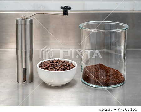 Roasted coffee beans, grinded bean in glass jug and manual grinder Roasted coffee beans, grinded bean in glass jug and manual grinder 77565165