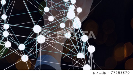 Network of connections with a businessman's hand in the background, networking concept 77568370